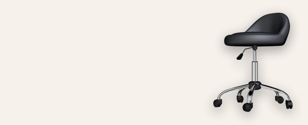 Black adjustable salon stool on wheels on a warm cream background