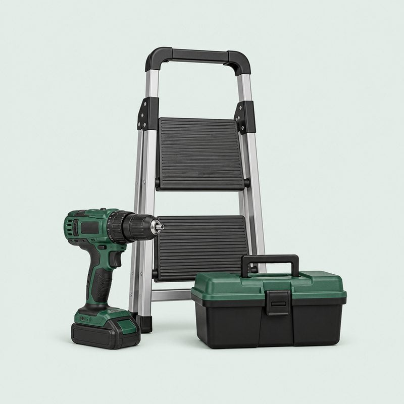 Cordless drill, step ladder and toolbox on a pale sage background